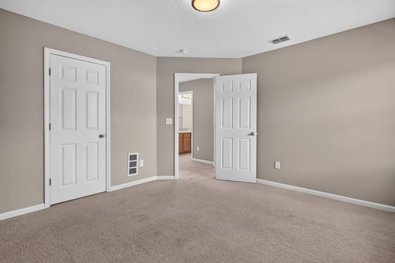 Bedroom with carpet and two doors at 13685 Goodson Pl, Jacksonville, FL 32226