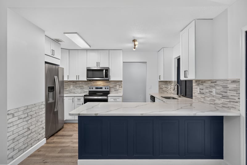 Kitchen with white cabinets and stainless appliances at 551 Deltona Blvd, St. Augustine, FL 32086