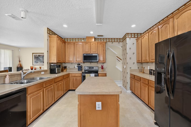 Kitchen with sink and black appliances at 2875 Pebblewood Ln, Orange Park, FL 32065