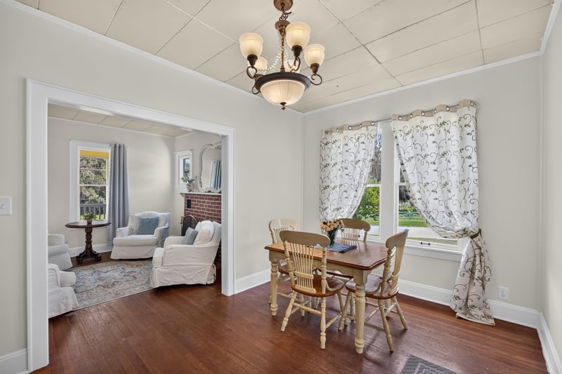 Dining room with lace curtains and chandelier at 101 N Lake St, Crescent City, FL