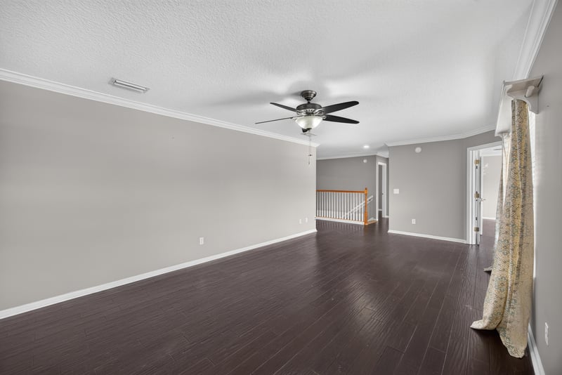 Empty room with wood floors and curtain at 1493 Greyfield Dr, St. Augustine, FL 32092