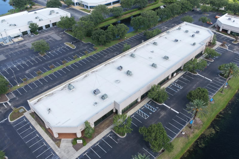 Aerial view of a building roof and surrounding parking lot at 10550 Deerwood Park Blvd, Jacksonville, FL 32256