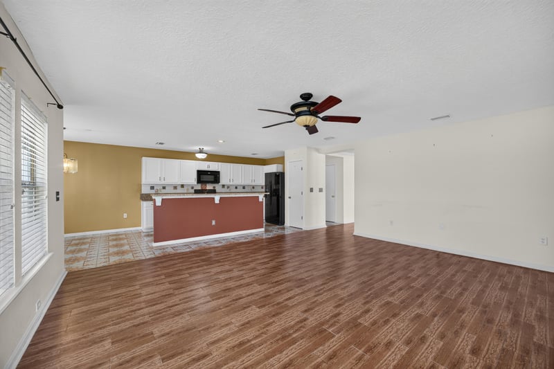 Empty family room with view to kitchen at 2282 Justin Lake Dr, Jacksonville, FL