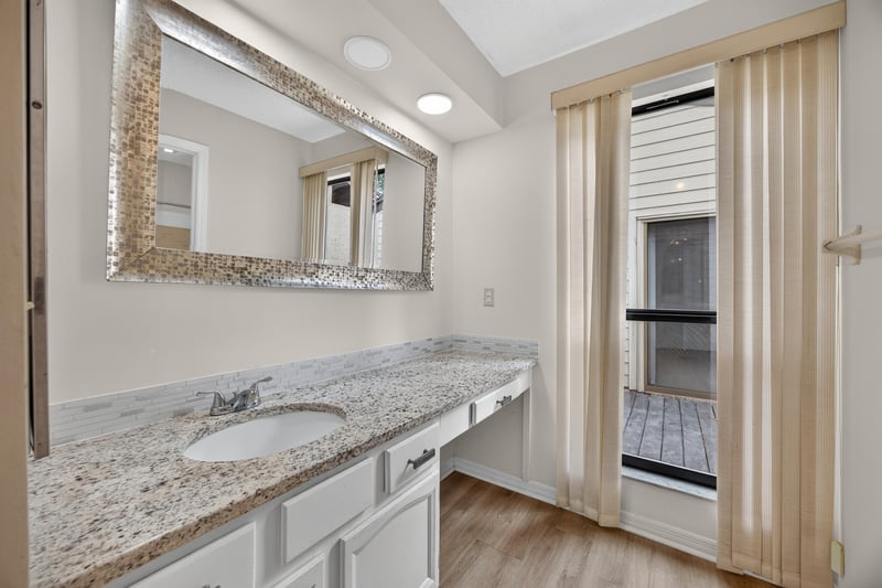 Bathroom vanity with mirror and window at 3407 Fairbanks Grant Rd N, Jacksonville, FL 32223