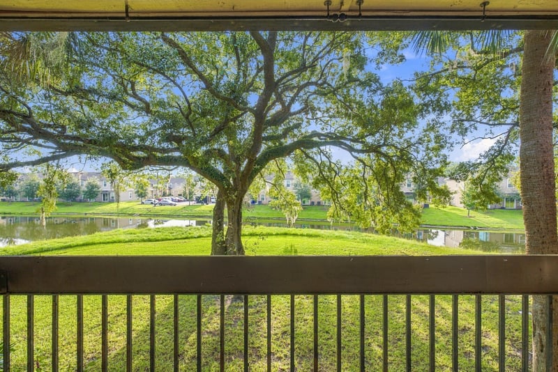 Balcony view of oak tree and open grass at 7703 Las Palmas Way