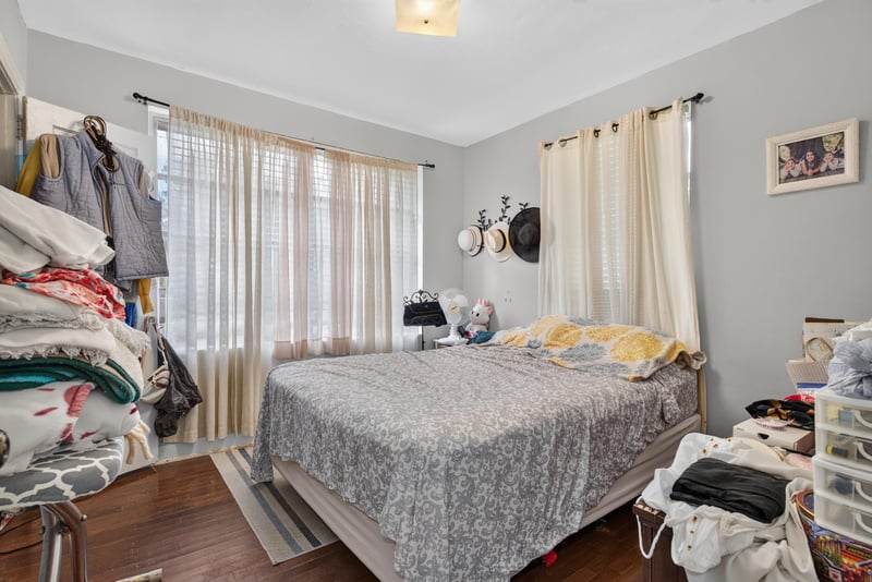 Bedroom with bed and curtained window at 5745 110th St, Jacksonville, FL 32244