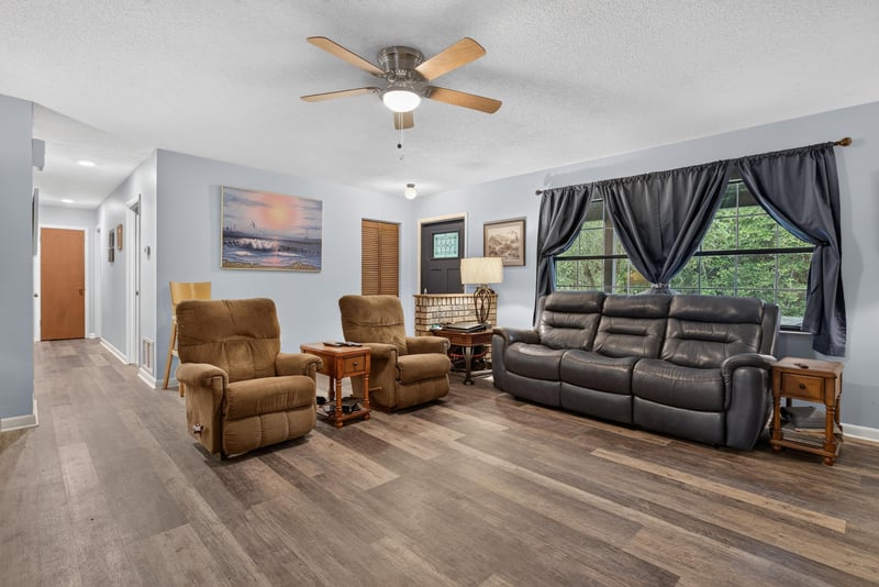 Living room with recliners and wood-look flooring at 3249 Maryland Ave, Green Cove Springs, FL