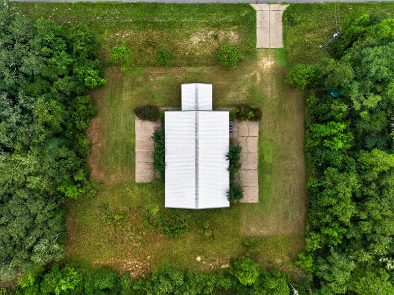 Drone aerial straight down of the building and surrounding lawn at 1038 County Rd 315, Melrose