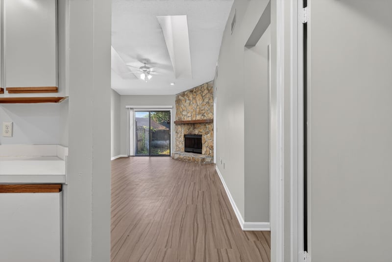 Hallway view toward the living room fireplace at 8010 International Village Dr, Jacksonville, FL 32277