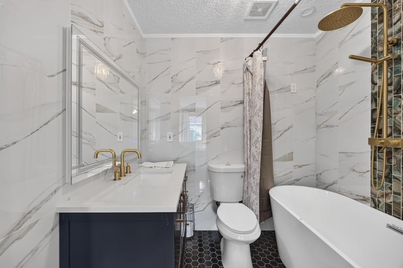 Bathroom with marble tile and glass shower at 2125 Blue Heron Cove Dr, Orange Park, FL 32003