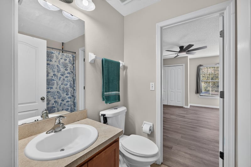 Bathroom with shower and hallway doorway at 7723 Playschool Ln, Jacksonville, FL