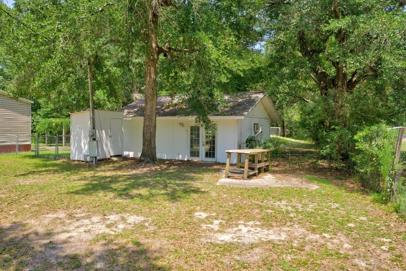 Yard view near outbuilding with picnic table at 2549 Snapdragon Ave, Middleburg, FL 32068