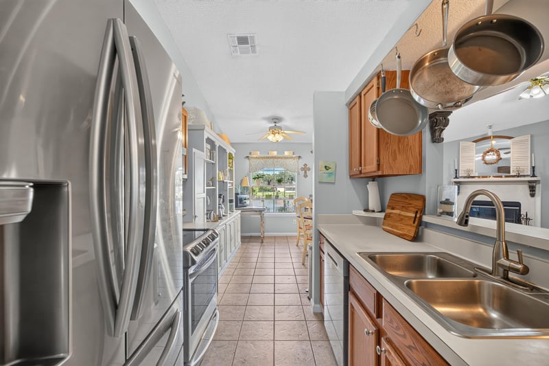 Kitchen with stainless refrigerator and hanging pot rack at 4556 Shaky Leaf Ln N, Jacksonville, FL 32224