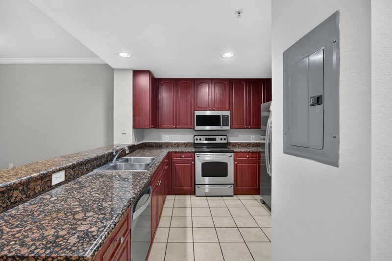 Kitchen with cherry cabinets and granite counters at 9745 Touchton Rd, Jacksonville, FL 32246