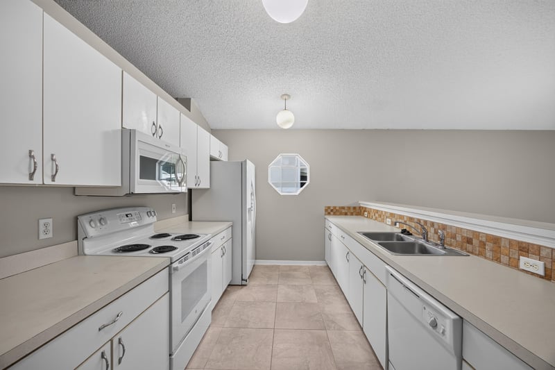 Kitchen with white appliances and counter space at 1845 Saga Ct, Middleburg, FL