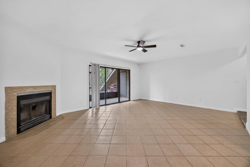 Brick fireplace and sliding glass door to porch at 3801 Crown Point Rd unit 2061, Jacksonville, FL 32257