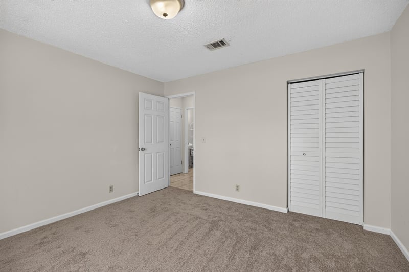 Bedroom with carpet and closet doors at 2829 Blackberry Ave