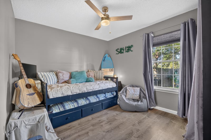 Bedroom with daybed and guitar decor at 4556 Shaky Leaf Ln N, Jacksonville, FL 32224