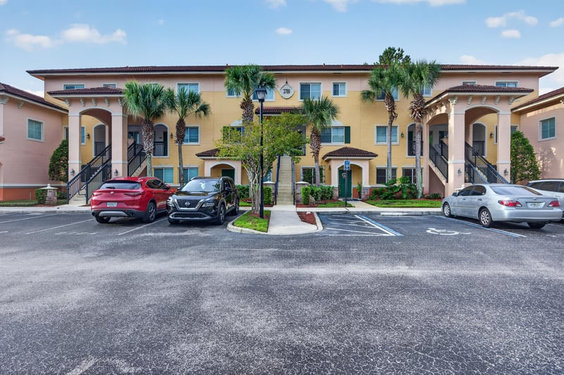 Mediterranean-style condo building exterior with parking lot at 9745 Touchton Rd, Jacksonville, FL 32246