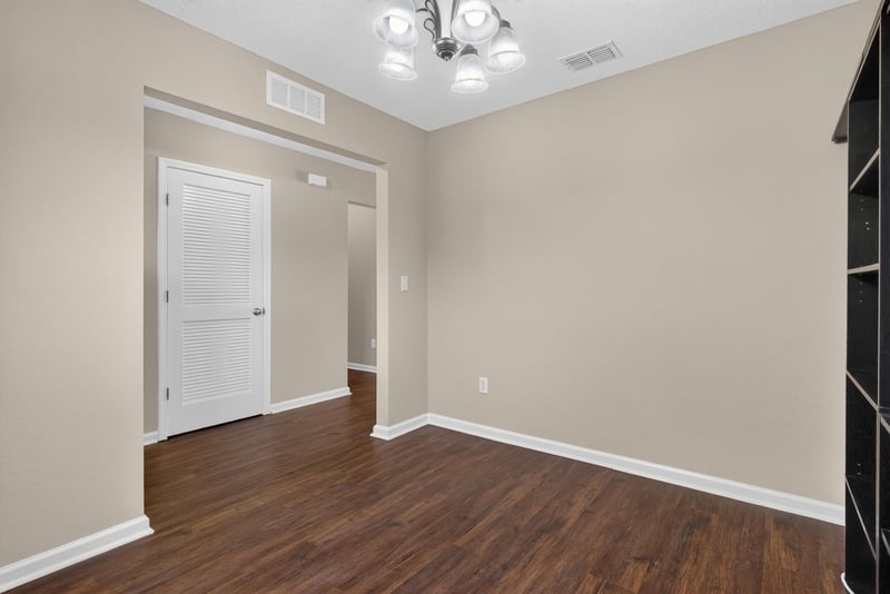 Empty room with wood-look flooring and doorway at 7253 Townsend Village Ct, Jacksonville, FL