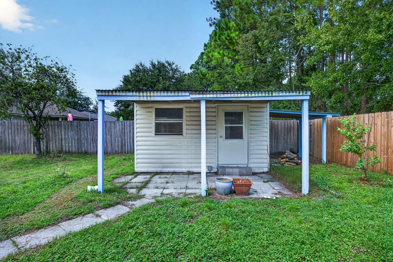 Rear exterior with AC unit and fence at 9691 Nelson Forks Dr, Jacksonville, FL 32222