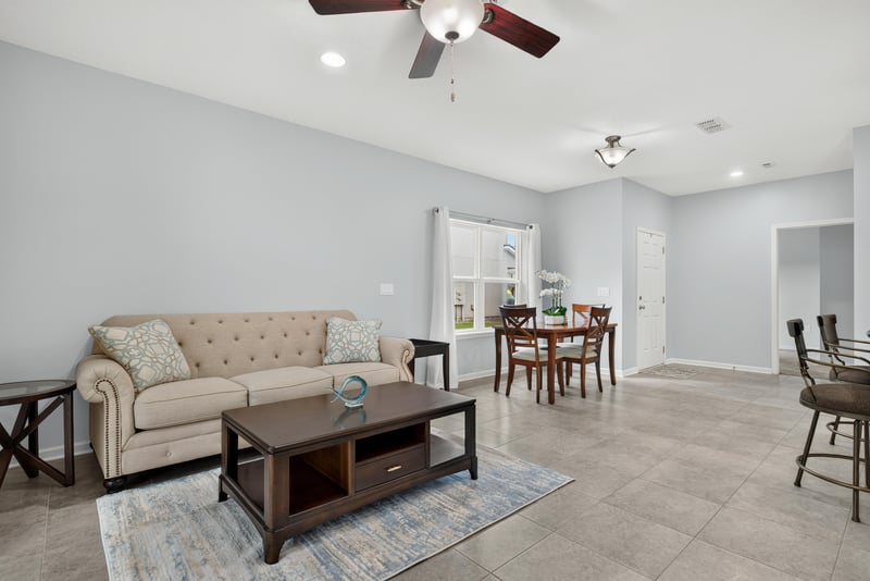 Living room with sofa and dining area beyond at 2378 Caney Oaks Dr, Jacksonville, FL