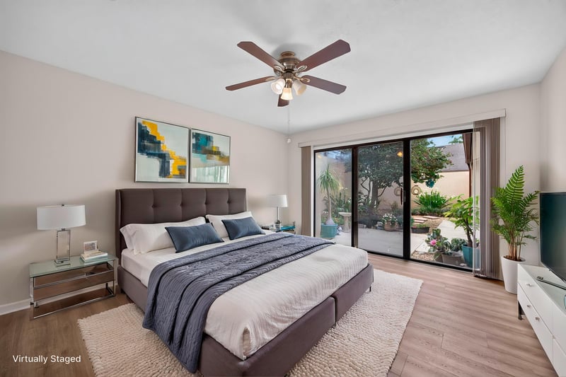 Staged bedroom with sliding glass doors at 3407 Fairbanks Grant Rd N, Jacksonville, FL 32223