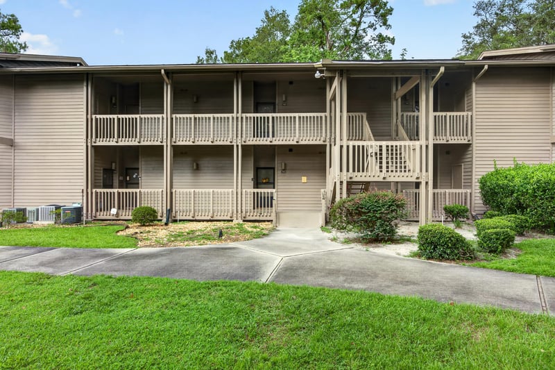 Two-story condo building exterior with covered balconies at 2910 Ravines Rd, Middleburg, FL 32068