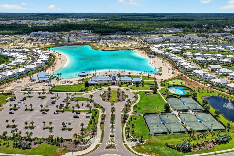 Lagoon, clubhouse and pickleball courts from above in Beachwalk, St. Johns, FL