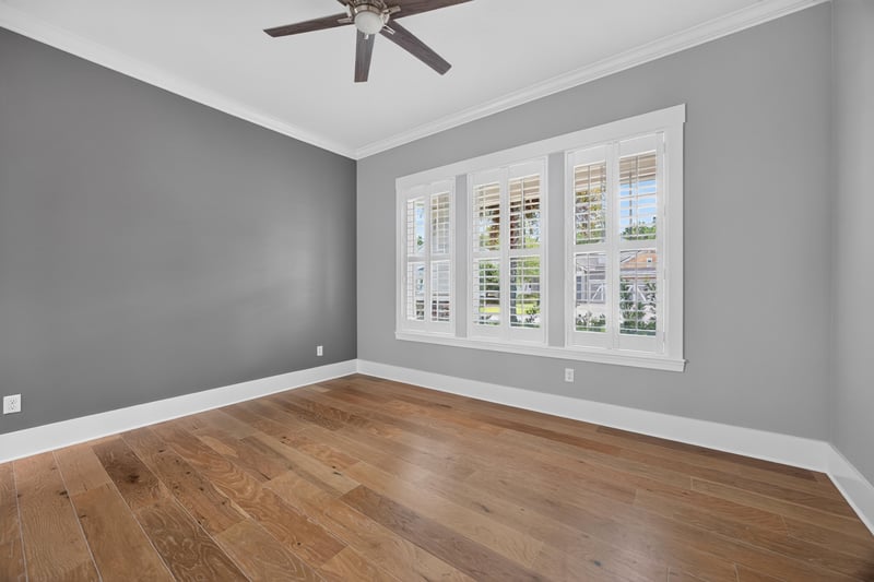 Bedroom with ceiling fan and windows at 186 Freshwater Dr
