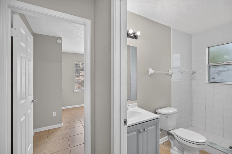 Bathroom with vanity mirror and toilet at 1040 Willow Cove Ct E, Jacksonville, FL 32233