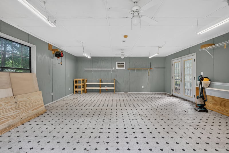 Interior of outbuilding with tile floor and workbenches at 2549 Snapdragon Ave, Middleburg, FL 32068