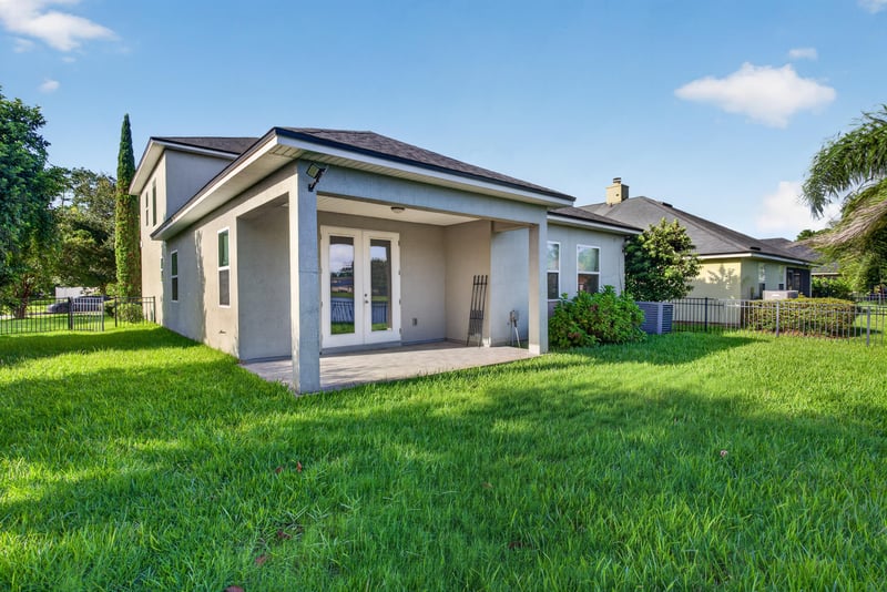 Rear exterior covered patio and backyard at 13685 Goodson Pl, Jacksonville, FL 32226