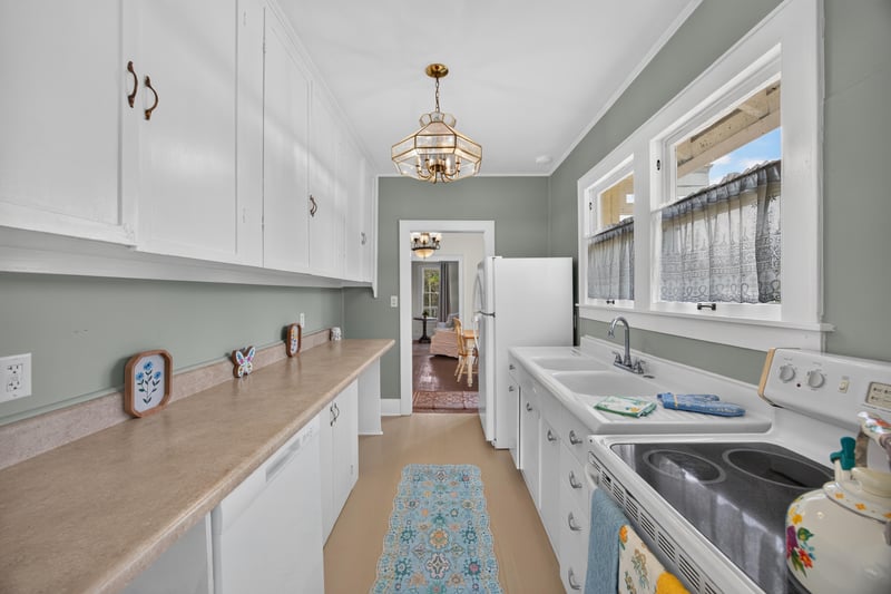Kitchen with white cabinets and pendant light at 101 N Lake St, Crescent City, FL