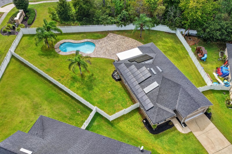Aerial view of roof solar panels and pool at 706 Grampian Highlands Dr, St. Johns, FL 32259