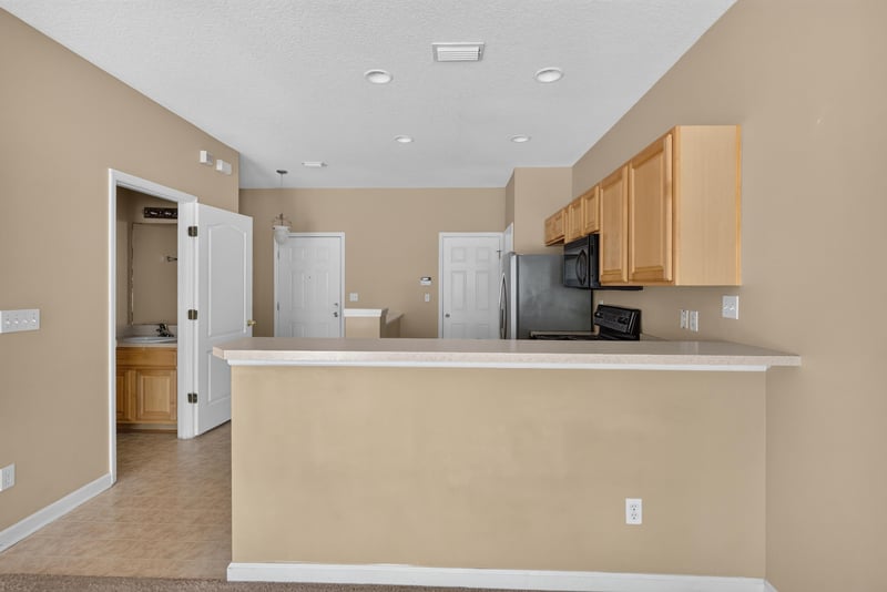 Kitchen peninsula looking toward entry hall at 12359 Mangrove Forest Ct, Jacksonville, FL 32218