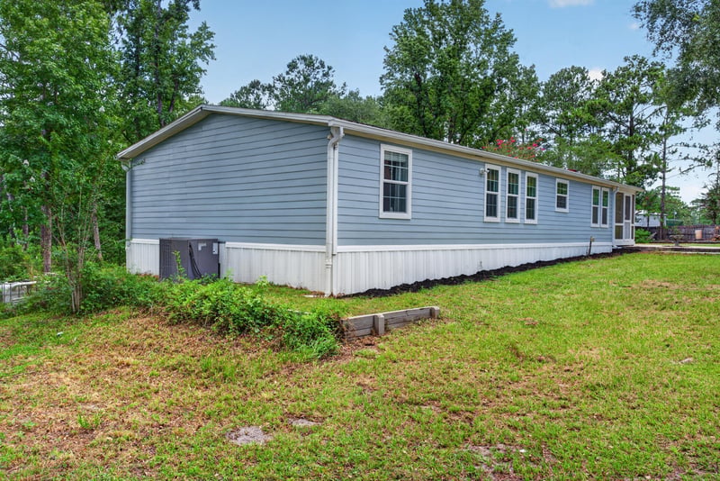 Side exterior view of home with open yard at 4890 McAllister Rd, Middleburg, FL 32068