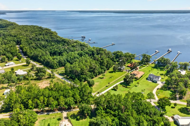 Aerial view of the river with a dock and nearby homes at 110 River Shores Rd, Palatka, FL 32043