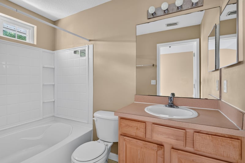 Bathroom with tub-shower and vanity at 12359 Mangrove Forest Ct, Jacksonville, FL 32218