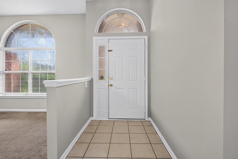Entry foyer with arched window above the door at 11669 Collins Creek Dr, Jacksonville, FL 32258