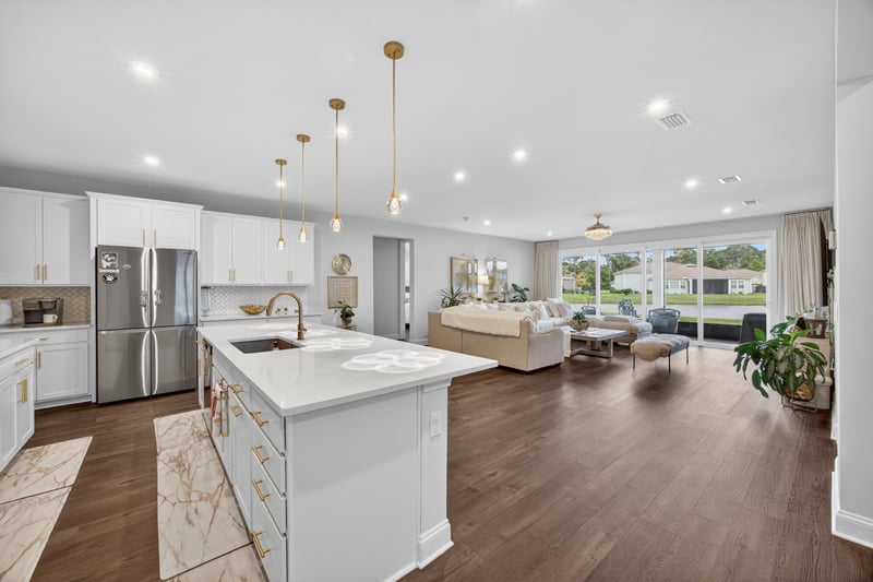 Kitchen island and living area with pendant lighting at 85491 Fall River Pkwy, Fernandina Beach, FL 32034
