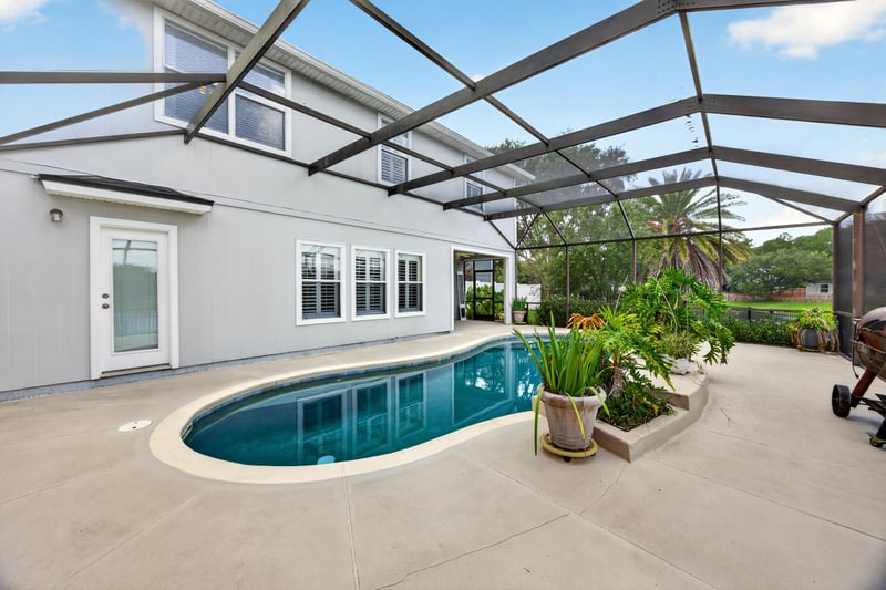 Screened pool and patio with lake view at 1493 Greyfield Dr, St. Augustine, FL 32092