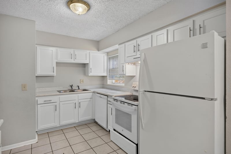 Kitchen view with white cabinets and tile floor at 2658 Trollie Ln apt 1, Jacksonville, FL 32211