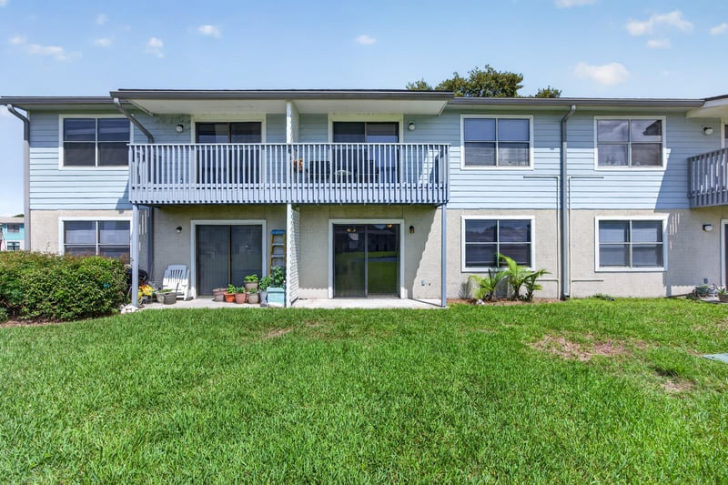 Rear exterior of the condo building with balcony and screened porch at 700 W Pope Rd unit h61, St. Augustine, FL 32080