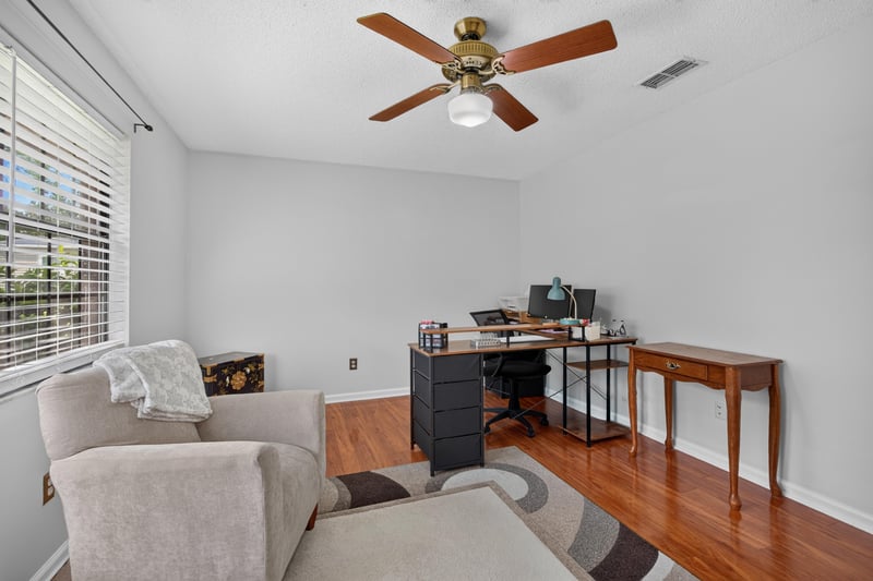 Office area with desk and wood flooring at 2435 Range Line Rd, Middleburg, FL