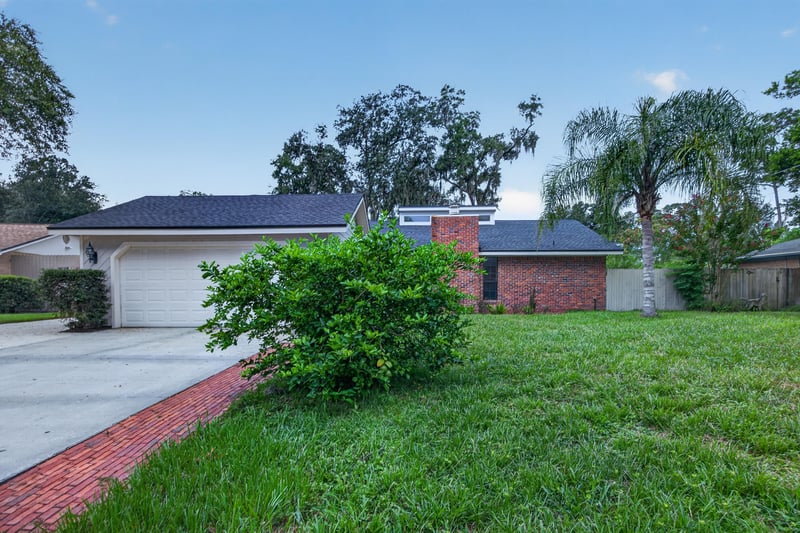 Front exterior at day-to-dusk showing garage and landscaping at 12344 Cormorant Ct, Jacksonville, FL
