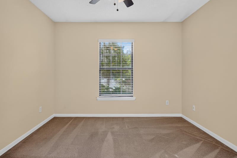 Empty bedroom with carpet and window at 353 Redwood Ln