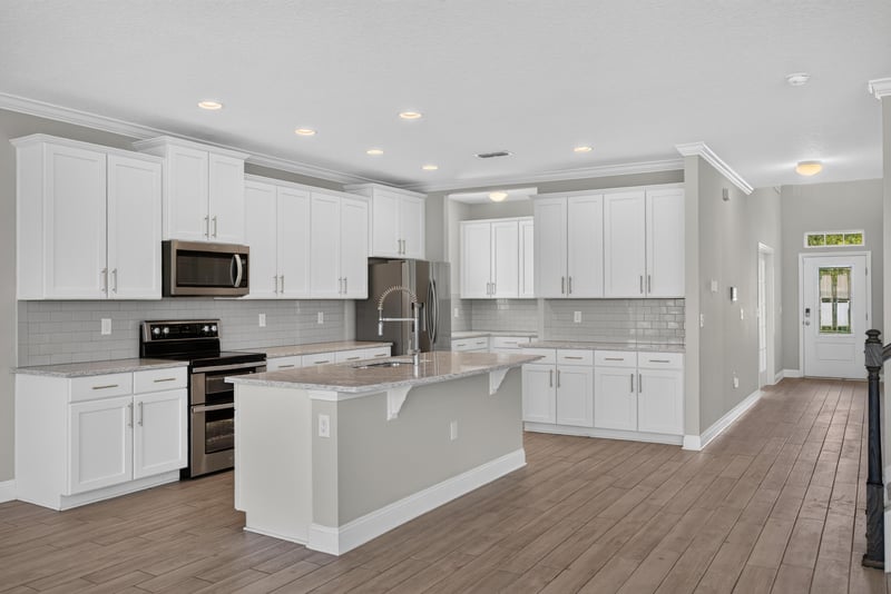 Kitchen with white cabinets and center island at 2580 Cold Stream Ln, Green Cove Springs, FL 32043