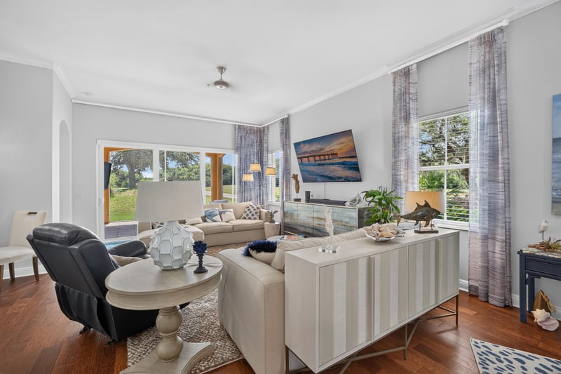 Living area with round dining table and wood floors at 140 Ave De La Mer, Palm Coast, FL 32137