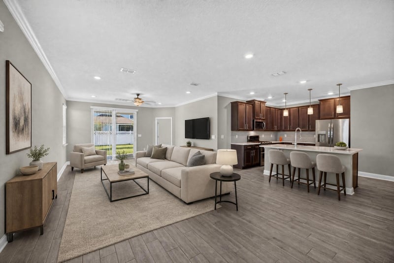 Open living room and kitchen, virtually staged, at 331 Millerstone Dr, St. Augustine, FL 32092